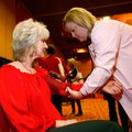 Laura Marks (above) of Bentonville has her blood pressure checked Tuesday by Leisa Lee, registered n...