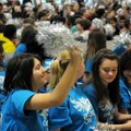 Shy Montenegro, 13, joins other students to wave silver pompoms during the ceremony.