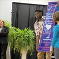 Zoe Reif, 12, from right, and Maynard Valley, 13, both students at Owl Creek School, hold a banner T...