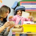 Maerissa Knapp, left, teacher at First School, looks at stamps with Cora Cox, 3, during a post offic...
