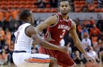 Auburn's Josh Wallace (11) defends Arkansas' Rickey Scott (3) during an NCAA college basketball game on Wednesday, Feb. 13, 2013, at Auburn Arena in Auburn, Ala. The Razorbacks beat the Tigers 83-75.(AP Photo/Al.com, Julie Bennett)