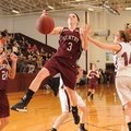 Tara Arnold, center, of Gentry is fouled on her way to the basket Wednesday by Lincoln’s Jaycie Neel...