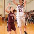 Nikki Thordsen, right, of Lincoln puts up a shot Wednesday in front of Gentry’s Shelby Hammond durin...