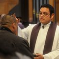 The Rev. Juan Manjarrez brushes ashes on those attending an Ash Wednesday service at St. Vincent de ...