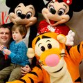 Max Rogers, 4, and his father, Brian Rogers, pose for photos Wednesday with Disney characters on at ...