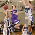 Cameron Paschke, center, a Fayetteville senior point guard, takes the ball to the basket between Rog...