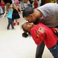 Dontai Nash, (above) right, dips down to give his daughter, Jaden Nash, 7, a kiss on the cheek Thurs...
