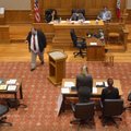 Robert Goins, left, University of Arkansas law student with the school’s law team, walks back to his...