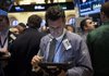 Glen Kessler, a trader with Raven Securities Corp., works Friday on the floor of the New York Stock Exchange. The stock indexes ended the week with a day of slight losses. 