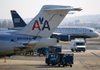 A US Airways Group Inc. jet taxis near one of AMR Corp.’s American Airlines jets at Reagan National Airport in Washington, D.C. Corporate takeovers and mergers, including the planned US Airways and American Airlines merger, have taken off this year. 
