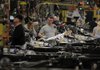 Employees work on the assembly line at the Ford Motor Co. Dearborn Truck Plant in Dearborn, Michigan, U.S., on Thursday, Dec. 13, 2012. Ford's Dearborn Truck Plant, a flagship of the next generation of lean and flexible facilities, is capable of building up to nine different models for three vehicle platforms, while maintaining an environmentally friendly manufacturing processes. Photographer: Jeff Kowalsky/Bloomberg
