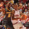 Arkansas sophomore guard BJ Young, right, drives along the baseline as Missouri senior Keion Bell de...