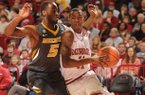 Arkansas sophomore guard BJ Young, right, drives along the baseline as Missouri senior Keion Bell defends Saturday in Bud Walton Arena in Fayetteville. Young scored 18 points, including seven points in the final 29 seconds, as the Razorbacks beat Missouri 73-71.