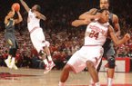 Arkansas freshman Michael Qualls and Missouri senior forward Laurence Bowers get tangled up in the lane as Missouri junior guard Phil Pressey, left, takes a shot over Arkansas junior forward Marshawn Powell Saturday, Feb. 16, 2013, during the second half of play in Bud Walton Arena in Fayetteville. Qualls and Bowers received a double techincal in the game.