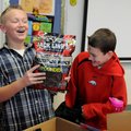 Nick Boetel, 12, (above) laughs Friday after his friend Thomas Wiebe, 11, gives him a large bag of b...