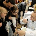 Spencer Deal, from right, with Rove Pest Control, shows Jeremy Fifield, Kailee McDonald, 8, and Lore...