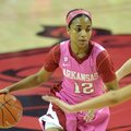Arkansas' Dominique Wilson tries to get past the Missouri defenders in the second half of Sunday aft...