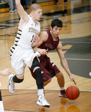 STAFF PHOTO JASON IVESTER
Siloam Springs senior Raul Leyva (right) tries to get around Bentonville freshman Tyrik Dixon during the second half on Friday, Feb. 15, 2013, against Siloam Springs at Bentonville High School.
