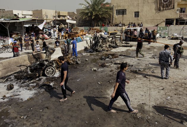 iraqis-inspect-the-scene-of-a-car-bomb-attack-in-the-ameen-neighborhood-in-eastern-baghdad-iraq-sunday-feb-17-2013-a-series-of-car-bombs-exploded-within-minutes-of-each-other-as-iraqis-were-out-shopping-in-and-around-baghdad-on-sunday-killing-and-wounding-scores-of-people-police-said