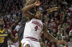Missouri's Alex Oriakhi, top, attempts to rebound against Arkansas' Coty Clarke (4) during the second half an NCAA college basketball game in Fayetteville, Ark., Saturday Feb. 16, 2013. Arkansas defeated Missouri 73-71. (AP Photo/Gareth Patterson)