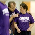 Terry Pourner, center, congratulates teammate Connie Patton, both playing for a team from Pathfinder...