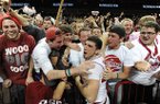 Arkansas junior guard Kikko Haydar celebrates with members of the student section Saturday, Feb. 16, 2013, after beating Missouri at Bud Walton Arena in Fayetteville.