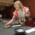 Brenda Compton looks over item No. 67 Monday at the Arend Arts Center in Bentonville during the Crea...