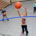 Logen Dildy, 7, left, waits for his brother, Hunter Dildy, 5, center, to shoot a basket into a hula ...