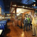 Mark Risk, right, a Realtor, points out details in the dining area of the Old Post Office building S...
