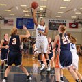 Rogers’ Taylor Strickland, center, puts a jump shot up over Rogers Heritage’s Ellen Lundy, left, and...