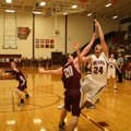 Lincoln junior Ossy Escareno attempts a shot under the basket but is fouled by Gentry sophomore Dust...
