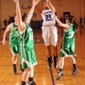 Skyler Johnson, an Elkins junior, takes a shot over Greenland junior Jenny Riggles. left, and senior...
