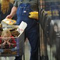 Dixie Bailey, 6, of Greenland waits Wednesday in a shopping cart as her grandfather, David Nicol of ...