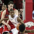 Arkansas' B.J. Young (11) spins toward the basket against Georgia's Nemanja Djurisic, center left, K...