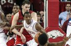 Arkansas' B.J. Young (11) spins toward the basket against Georgia's Nemanja Djurisic, center left, Kentavious Caldwell-Pope, bottom, and Donte Williams, rear left, before taking the winning shot to defeat Georgia 62-60 in an NCAA college basketball game in Fayetteville, Ark., Thursday, Feb. 21, 2013. (AP Photo/April L. Brown)