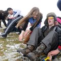 Drew Dilatush, second from right, holds on Wednesday as Miguel Ceballos, 17, right, and Carolina Mar...