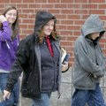 Barbara Long walks Wednesday with her daughter Jessica, 17, and son James, 12, as snow begins to fal...