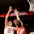 Arkansas forward Hunter Mickelson (21) shoots against Georgia's John Cannon (center) and Nemanja Dju...