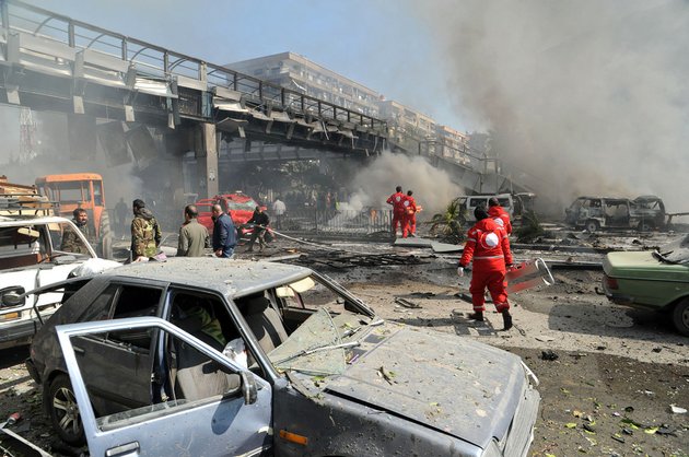 this-photo-released-by-the-syrian-official-news-agency-sana-shows-first-responders-working-after-a-huge-explosion-that-shook-central-damascus-syria-on-thursday-feb-21-2013