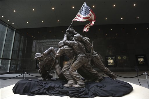 the-original-12-12-foot-4-meter-cast-stone-version-of-felix-de-weldons-iconic-statue-depicting-soldiers-raising-the-us-flag-at-iwo-jima-is-on-display-friday-feb-22-2013-the-smaller-original-statue-which-was-removed-in-1947-and-hidden-under-a-tarp-at-the-artists-studio-for-four-decades-is-expected-to-fetch-up-to-18-million-when-it-goes-on-sale-at-bonhams-auction-house-in-new-york-on-feb-22-2013