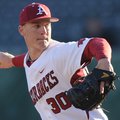 Arkansas junior reliever Brandon Moore delivers a pitch against Evansville Friday, Feb. 22, 2013, du...