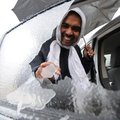 Shihab Kavungathodika pokes away at a sheet of ice Thursday that remained after rolling the window d...