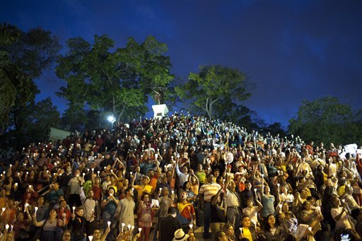 people-hold-up-candles-during-candlelight-vigil-for-venezuelas-president-hugo-chavez-to-pray-for-his-health-as-he-remains-in-a-hospital-undergoing-cancer-treatment-in-caracas-venezuela-friday-feb-22-2013-the-government-has-not-given-details-about-the-treatment-chavez-is-undergoing-and-hasnt-identified-the-type-or-exact-location-of-the-tumors-that-have-been-removed-from-his-pelvic-region