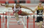 Arkansas senior Caleb Cross clears the final hurdle on his way to a second-place finish ahead of Missouri junior Andy Schuckenbrock in a preliminary heat of the 60-meter hurdles Saturday, Feb. 23, 2013, during the Southeastern Conference Indoor Track and Field Championships at the Randal Tyson Track Center in Fayetteville.