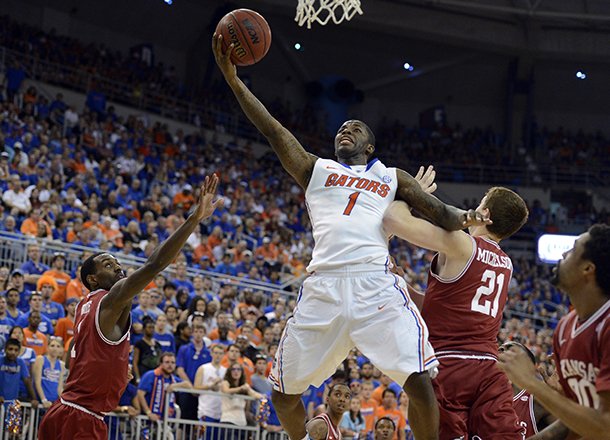 florida-guard-kenny-boynton-1-goes-to-the-basket-as-arkansas-guard-mardracus-wade-1-and-forward-hunter-mickelson-21-defend-during-the-first-half-of-an-ncaa-college-basketball-game-in-gainesville-fla-saturday-feb-23-2013-ap-photophil-sandlin