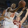 Florida's Erik Murphy (33) tries to block Arkansas guard Michael Qualls (24) as he struggles under t...