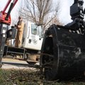 Rod Dorsey with Springdale Public Works operates a bulky waste grapple truck Friday to pick up tree ...