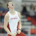 Arkansas sophomore Andrew Irwin celebrates a clearance at 18 feet, 4 1/4 inches to win the pole vaul...