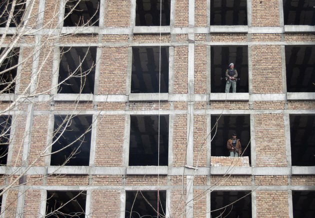 security-guards-for-the-afghan-intelligence-department-stand-guard-inside-a-half-built-building-near-the-scene-where-a-an-insurgent-was-shot-to-death-near-an-afghan-intelligence-office-in-kabul-afghanistan-sunday-feb-24-2013-a-series-of-early-morning-attacks-hit-eastern-afghanistan-sunday-with-three-separate-suicide-bombings-in-outlying-provinces-and-a-shootout-between-security-forces-and-a-would-be-attacker-in-the-capital-city-of-kabul