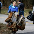 Cassandra Smith, 21, of Fayetteville carries a tent Saturday to a trash pile along the Scull Creek T...